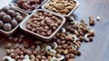 Wooden bowl with mixed nuts on table top view. Healthy food and snack. Walnut, pistachios, almonds, hazelnuts and Royalty Free Stock Photo