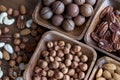 Wooden bowl with mixed nuts on table top view. Healthy food and snack. Walnut, pistachios, almonds, hazelnuts and Royalty Free Stock Photo