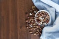 Wooden bowl with mixed nuts on table top view. Healthy food and snack. Walnut, pistachios, almonds, hazelnuts and Royalty Free Stock Photo