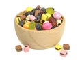 A wooden bowl of mixed sweets