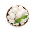 Wooden bowl with mozzarella cheese balls and basil on white background, top view Royalty Free Stock Photo