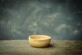 Wooden bowl on old rusted wood background