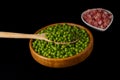 wooden bowl with peas and white bowl with iberian ham Royalty Free Stock Photo