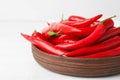 Wooden bowl with red hot chili  on white table, closeup Royalty Free Stock Photo
