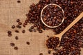 Wooden bowl with roasted coffee beans on rustic background