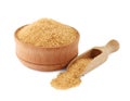 Wooden bowl and scoop of granulated brown sugar on white background