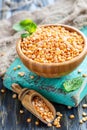 Wooden bowl and scoop with yellow split peas. Royalty Free Stock Photo