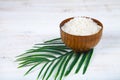 Wooden bowl with sea salt and palm leaf Royalty Free Stock Photo