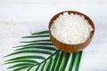 Wooden bowl with sea salt and palm leaf Royalty Free Stock Photo