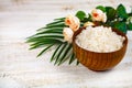 Wooden bowl with sea salt, rose and palm leaf Royalty Free Stock Photo