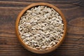 Bowl of shelled sunflower seeds on wooden board. Top view. Flat lay Royalty Free Stock Photo