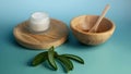 a wooden bowl and some wooden spoons with a small container next to it Royalty Free Stock Photo