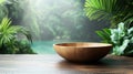 Wooden bowl on wooden table amidst lush tropical greenery Royalty Free Stock Photo