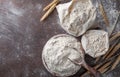 Wooden bowl of wheat flour on kitchen background top view. Ingredient for baking