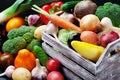 Wooden box with autumn harvest farm vegetables and root crops. Healthy and organic food background. Royalty Free Stock Photo