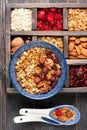Wooden box with breakfast items - oats, granola muesli, nuts, honey, dried berries and milk. Top view. Royalty Free Stock Photo