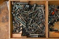 Wooden box with a bunch of nuts, bolts and screws. Royalty Free Stock Photo