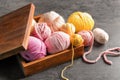 Wooden box with colorful knitting yarn on table Royalty Free Stock Photo