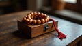Wooden box containing a string of amber beads with a red tassel. Generative AI Royalty Free Stock Photo