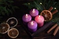 Wooden box with four purple burning advent candles Royalty Free Stock Photo