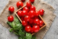 Wooden box with fresh ripe cherry tomatoes on table Royalty Free Stock Photo