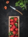 Wooden box with fresh strawberries, mint leaves and old knife on the table. Royalty Free Stock Photo