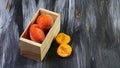 Wooden box with fresh sweet peaches on a dark background. Seasonal harvest crop local produce concept. Flat lay. Copy space Royalty Free Stock Photo