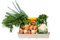 Wooden box of fresh vegetables from farmers market on white painted wood table Royalty Free Stock Photo