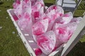 Wooden box full of cornets filled with pink petal roses for wedding