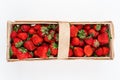 Wooden box full of red ripe strawberries isolated on white background, photographed directly from above. Harvesting summer fruits Royalty Free Stock Photo