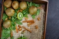 A wooden box with juicy kiwis in a mason jar on a dark gray background, top view. Kiwi on wooden tray. Copy space