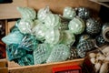 Wooden box of many blue silver toy bulbs of different shapes