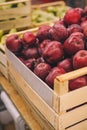 Wooden box of red apples in shop, supermarket, fruit department. Fresh ripe seasonal fruits, autumn vitamin harvest. Shop local