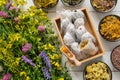 Wooden box of tea bags filled with dry medicinal herbs and bowls of dry healing plants. Bunch of medicinal herbs on wooden table. Royalty Free Stock Photo