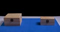 Wooden boxes on black background and blue mat