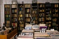 Wooden boxes with a collection of vinyl records against the background of shelves with books, libraries