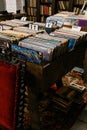 Wooden boxes with a collection of vinyl records against the background of shelves with books, libraries Royalty Free Stock Photo