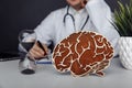 Wooden brain and hourglass in doctor& x27;s office. Dementia concept