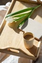 Wooden breakfast tray with cup of coffee, tulip flowers, diary on bed. Romantic, love concept Royalty Free Stock Photo