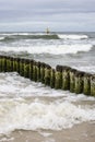 Wooden breakwater with Green algae in foaming water of Baltic Sea, Miedzyzdroje, Wolin Island, Poland Royalty Free Stock Photo