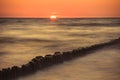 Wooden breakwater at sunset on the Baltic Sea Royalty Free Stock Photo