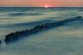 Wooden breakwater at sunset on the Baltic Sea Royalty Free Stock Photo