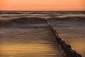 Wooden breakwater at sunset on the Baltic Sea Royalty Free Stock Photo