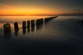 Wooden breakwater at the sunset over Baltic Sea Royalty Free Stock Photo