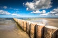 Wooden breakwaters on sandy Leba beach in late afternoon, Baltic Royalty Free Stock Photo