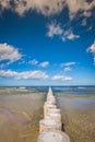 Wooden breakwaters on sandy Leba beach in late afternoon, Baltic Royalty Free Stock Photo