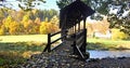 Wooden bridge above Weisse Elster with meadow and colorful autumn forest Royalty Free Stock Photo