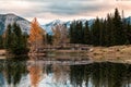 Wooden bridge in autumn forest reflection on Cascade ponds at Banff national park Royalty Free Stock Photo