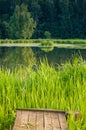 Wooden bridge on the background of a lake or river. Natural landscape near the water. Royalty Free Stock Photo