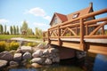 wooden bridge with brick supports over a prairie stream Royalty Free Stock Photo